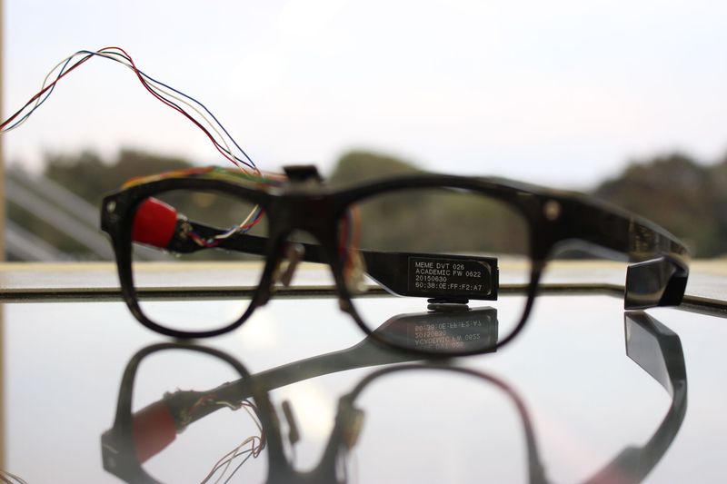 J!NS MEME academic prototype with sensor wiring on a glass table