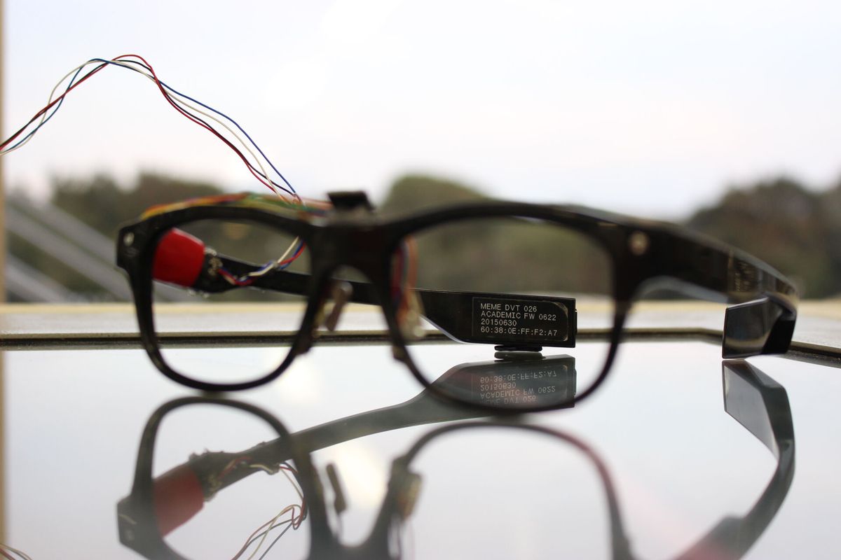J!NS MEME academic prototype with sensor wiring on a glass table